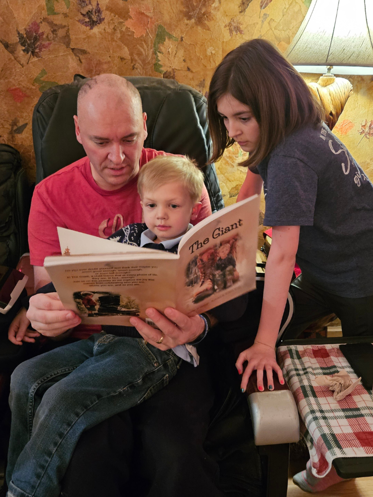 Dad reading The Giant to his two children